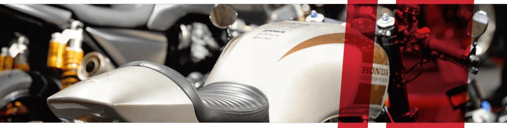 Designed header image with a detail shot of a white motorcycle